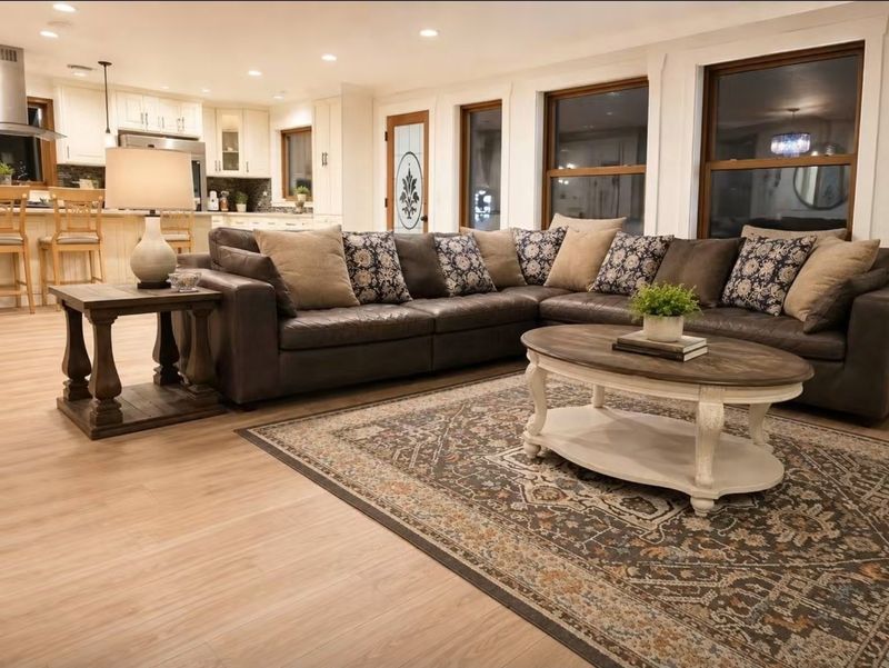 Warm shared living room at IMA House with seating and an open kitchen